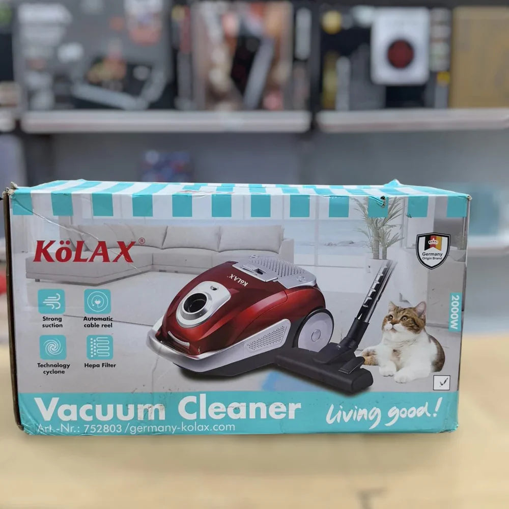 Kolax upright vacuum in use on carpet